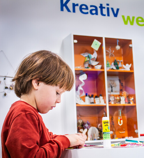 Junge bastelt in der Kreativwerkstatt.